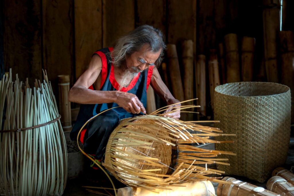 A weaver working on a traditional handwoven basket