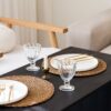 Woven placemats styled on a neutral dining table