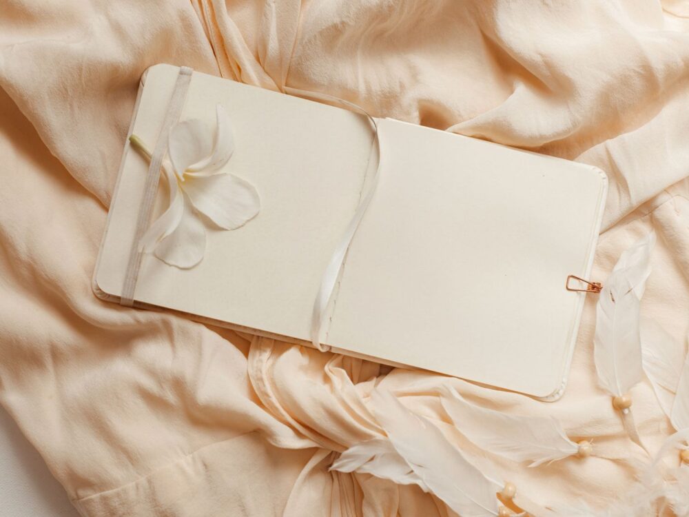 Textile covered notebook on soft neutral fabric