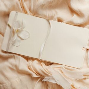 Textile covered notebook on soft neutral fabric