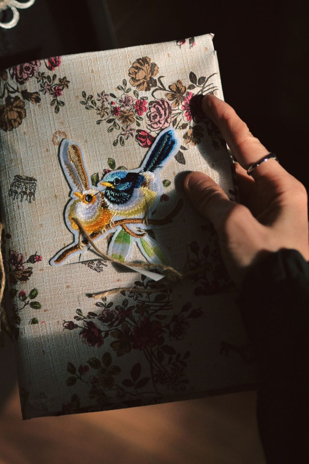 Embroidered textile notebook cover, artisan detail