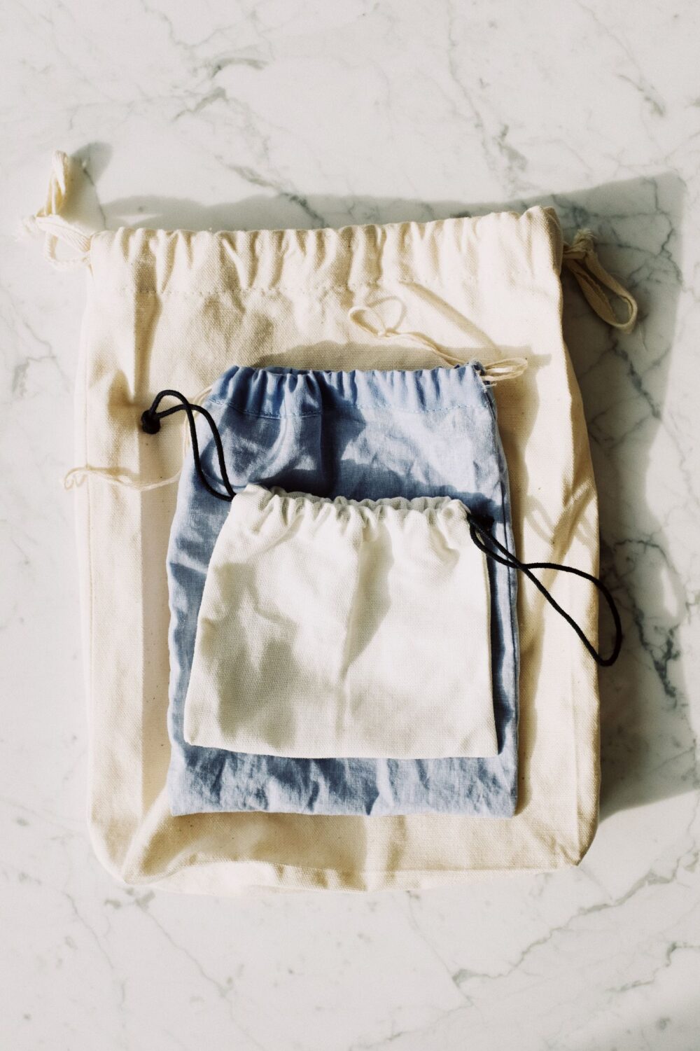 Set of handwoven drawstring pouches in natural tones