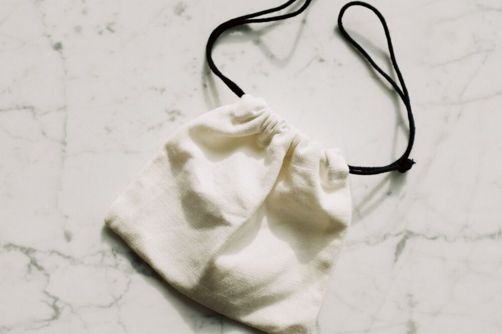 Linen drawstring sachet pouch on light surface