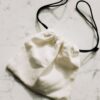 Linen drawstring sachet pouch on light surface
