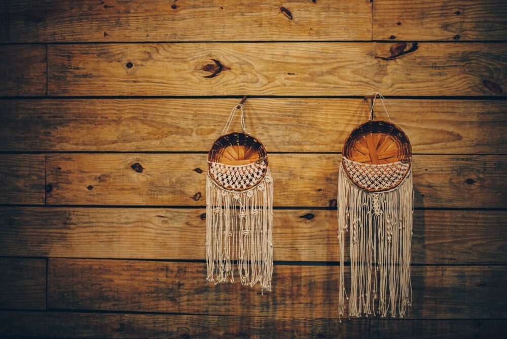 Woven wall discs hanging on a warm wooden wall