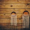 Woven wall discs hanging on a warm wooden wall